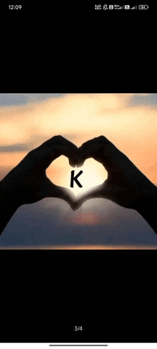a person is making a heart shape with their hands and the letter k is visible .