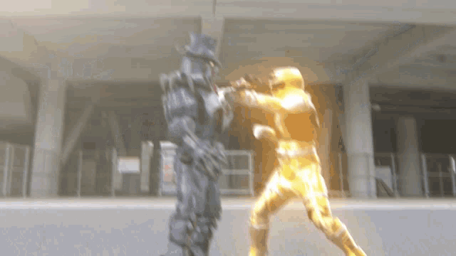 a blurry picture of a man in a suit fighting another man in a yellow suit