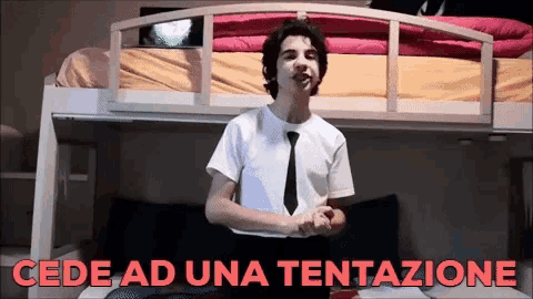 a man standing in front of a bunk bed with the words " cede ad una tentazione " written in red