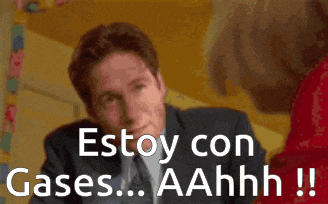 a man in a suit and tie says estoy con gases aahhh !