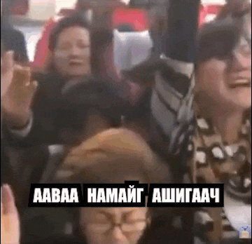 a group of people are sitting on a bus and making funny faces .