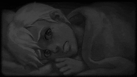a black and white photo of a woman laying on a bed