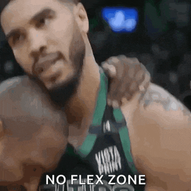 a basketball player is hugging another player with the words no flex zone on the bottom .