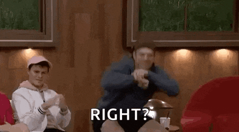 a man and a woman are sitting next to each other in a living room and dancing .