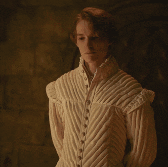 a man wearing a white jacket with buttons on the front