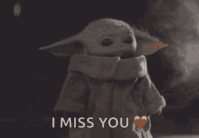 a baby yoda says i miss you with a heart in front of him