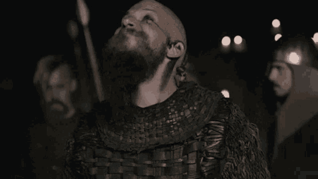 a man with a beard has a tattoo on his forehead that says ' ragnarok ' on it