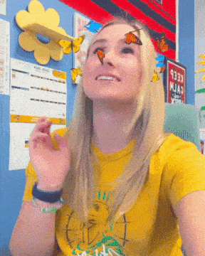 a woman wearing a yellow shirt with a statue of liberty on it