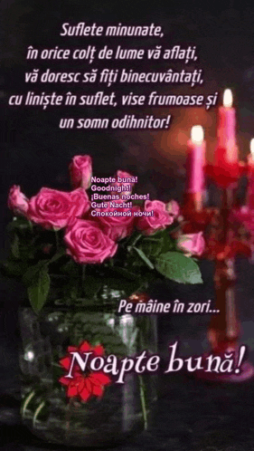a bouquet of pink roses in a vase with candles in the background ..