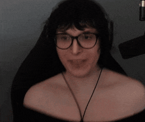 a woman wearing glasses and headphones is smiling