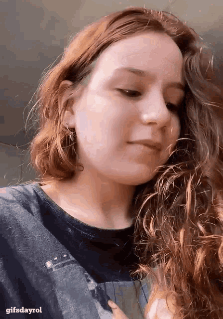 a close up of a woman 's face with the words gifsdayrol below her