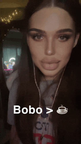 a close up of a woman with a cup of coffee next to her and the word bobo