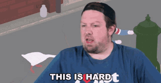 a man wearing a shirt that says " this is hard "