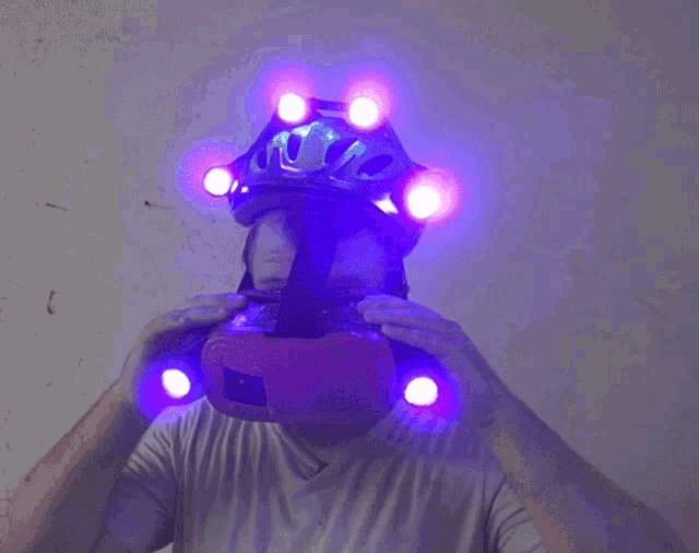 a person wearing a helmet with purple lights on the front