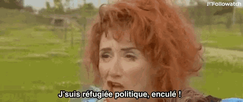 a woman with red hair is talking in a foreign language in a park .