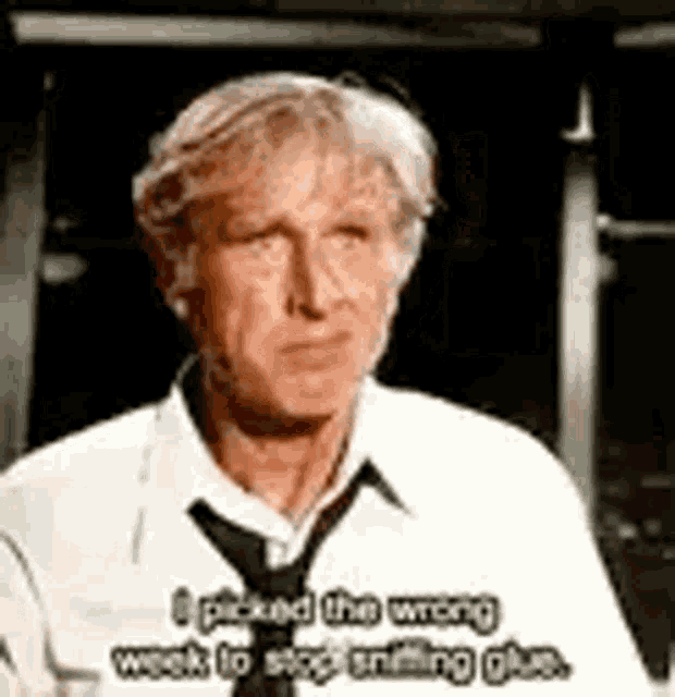 a man in a white shirt and tie is talking about something .