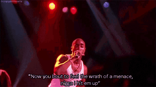 a man singing into a microphone with the words now you bout to feel the wrath