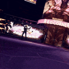a man stands in front of a sign that says musclehead colosseum red corner