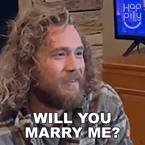 a man with curly hair and a beard asks if he will marry me