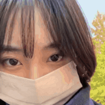 a close up of a woman wearing a mask covering her face .