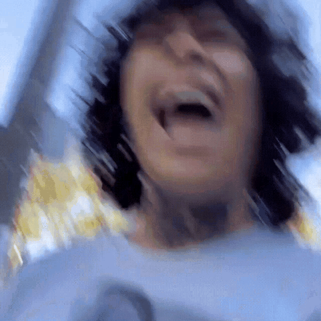 a blurry picture of a person laughing with their mouth wide open