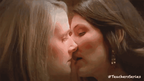 two women are kissing in front of a mirror with #teachersseries written below them