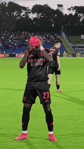 a soccer player wearing a jersey that says emirates fly better on it