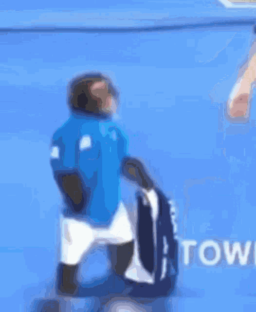 a blurry picture of a monkey holding a towel on a blue surface
