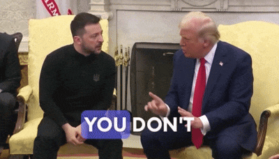 two men are sitting on a couch and one of them has a sticker that says you don 't