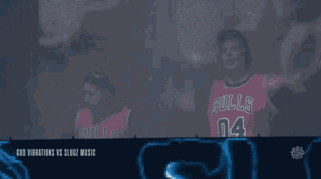 a man wearing a bulls jersey is standing in front of a blue background