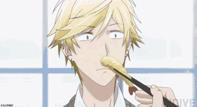 a man with blonde hair is eating a piece of food with chopsticks and the word live is on the bottom