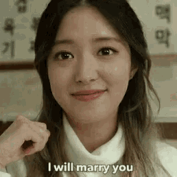 a close up of a woman 's face with the words `` i will marry you '' written on her face .
