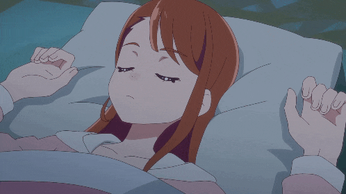 a girl laying in bed with her mouth open