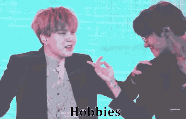 a couple of men standing next to each other with the word hobbies on the bottom right