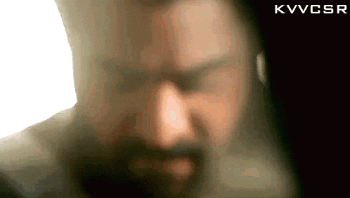 a blurry picture of a man 's face with the letters kvvcsr below him