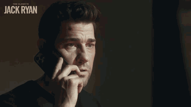 a man is talking on a cell phone with the name jack ryan on the bottom