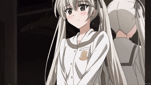 a girl with pigtails is wearing a white shirt with a badge on the sleeve