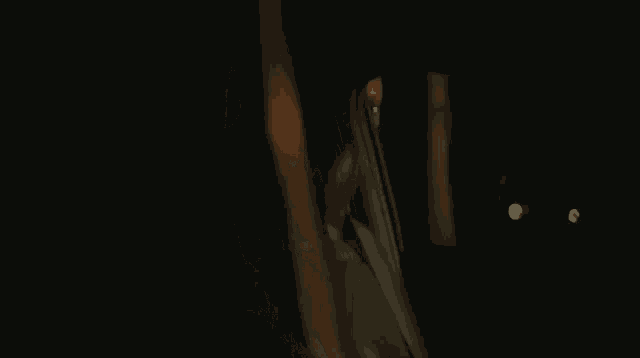 a woman is sitting in the back seat of a car at night looking out the window .