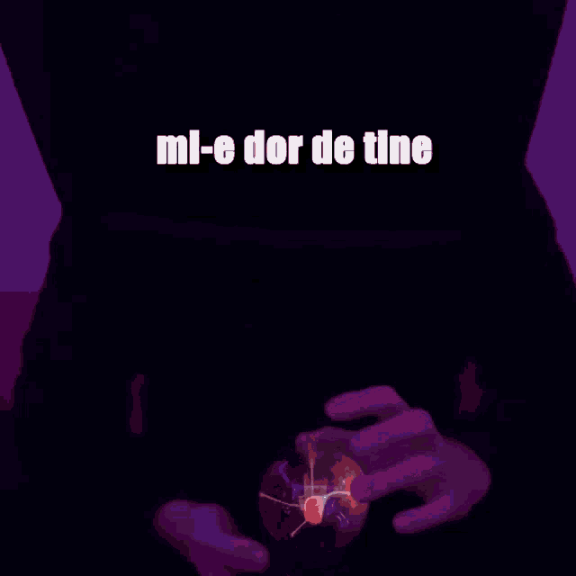 a person holding a glowing ball with the words mi-e dor de tine above it