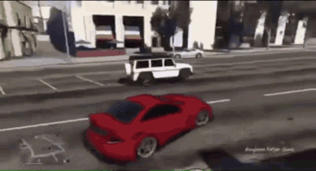 a red car is driving down a street next to a white vehicle