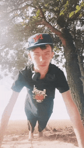 a young man wearing a black shirt that says jinnroll is doing push ups