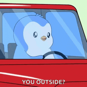 a penguin is driving a red car with the words `` you outside '' written on it .