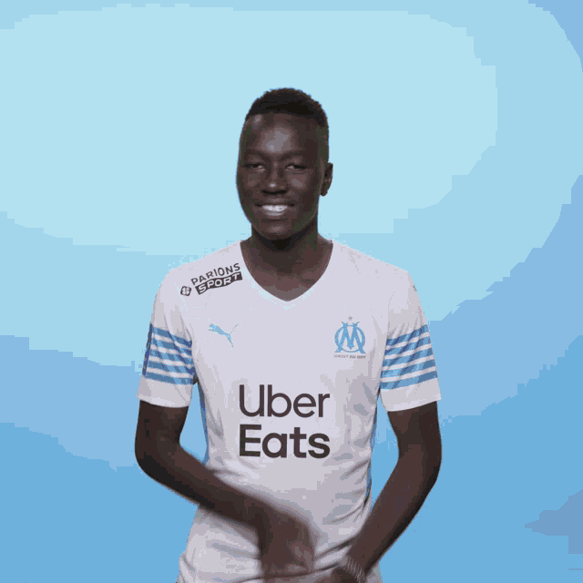 a man wearing an uber eats shirt is dancing
