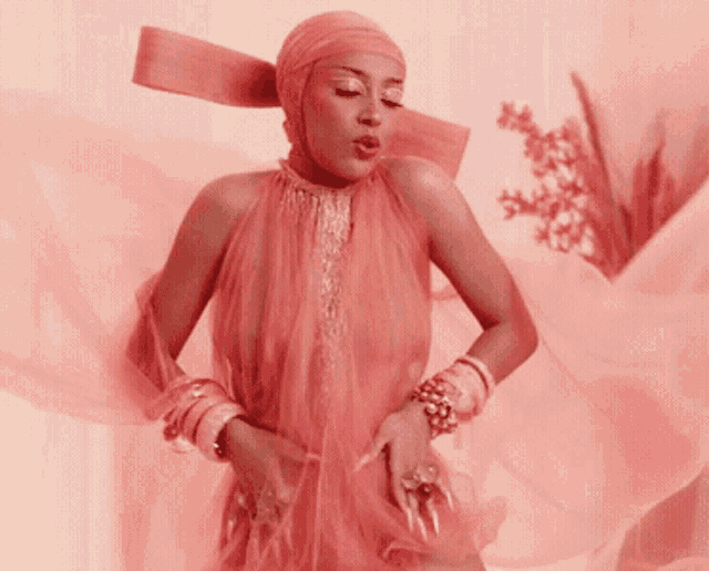 a woman wearing a pink dress and a head scarf