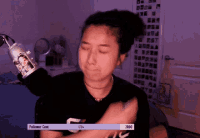 a woman sitting in front of a microphone with a follower count of 2000 on the bottom
