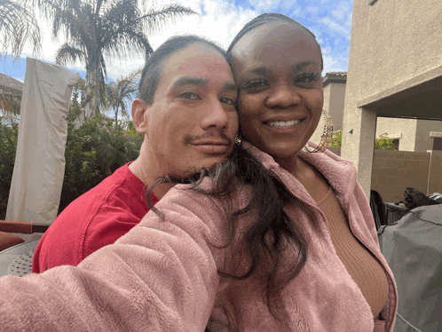 a man and a woman pose for a picture together