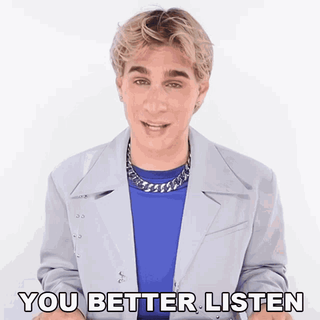 a man wearing a blue shirt and a grey jacket says " you better listen "