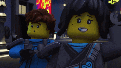 a boy and a girl are standing next to each other and the girl is smiling