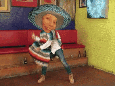 a person wearing a sombrero and a poncho dancing in a room