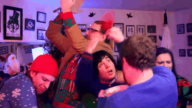 a group of people are gathered in a room with a poster on the wall that says ' oasis '